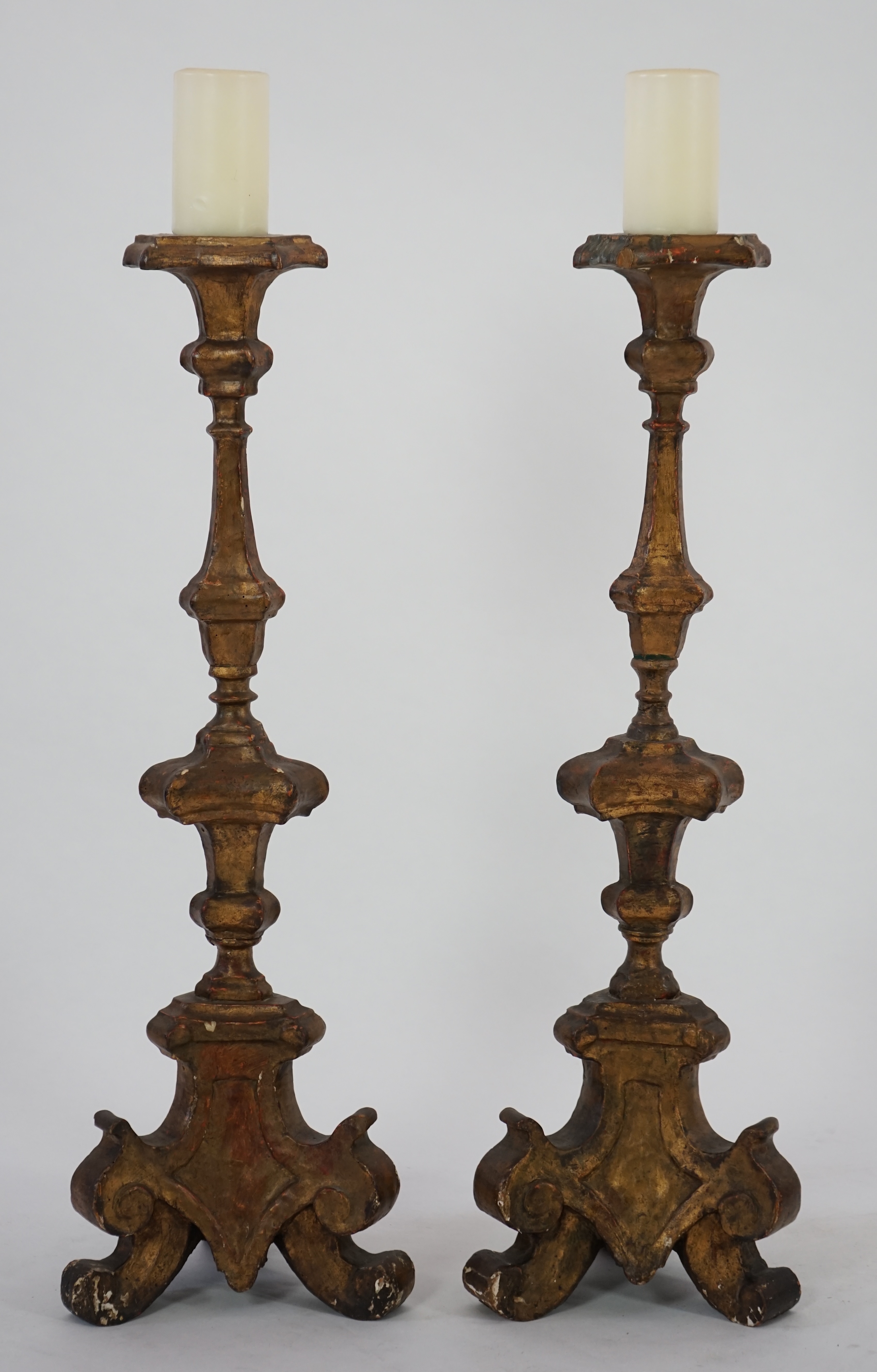 A pair of 18th century Italian giltwood candlesticks